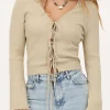 Beige Vestje Met Lurex & Strikjes