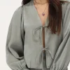 Groene Shiny Top Met Strikjes & Ruffle Mouwtjes